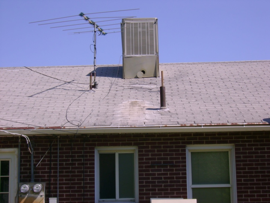 View of damaged roof and old gutters that need replacing